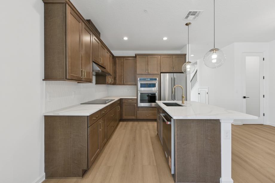 Gourmet kitchen boasting a large center island with quartz countertops