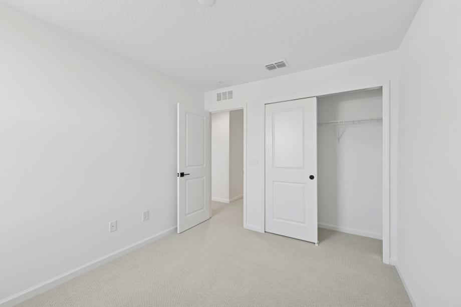 Well-appointed and versatile, the secondary bedroom offers comfort, privacy, and timeless appeal