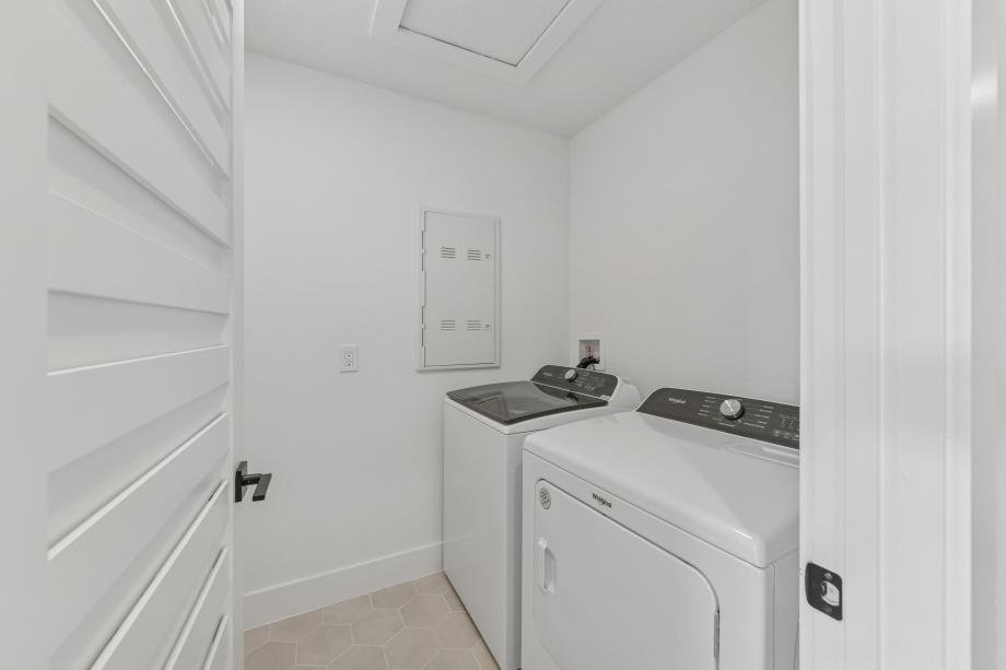 The laundry room combines efficiency and style with a thoughtfully planned layout and ample utility