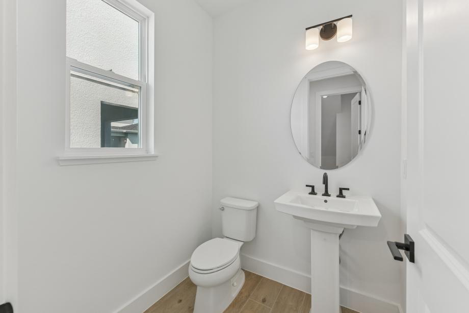 The powder room makes a stylish statement with thoughtfully selected details and polished designs