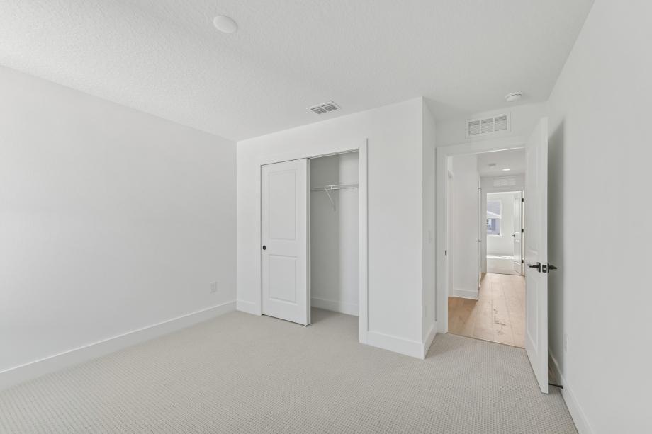 Well appointed and versatile, the secondary bedroom offers comfort, privacy, and timeless appeal