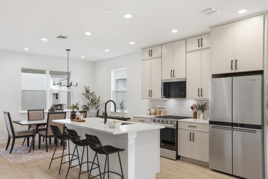 Gourmet kitchen boasting a large center island with quartz countertops