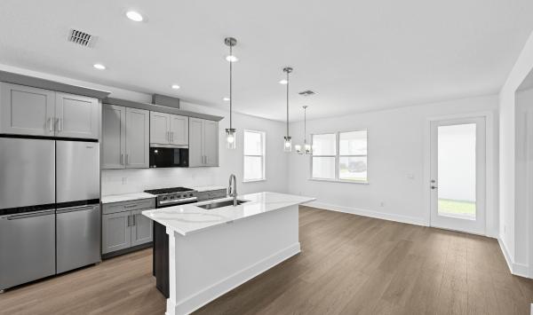 Well-appointed kitchens with large center islands and walk-in pantries