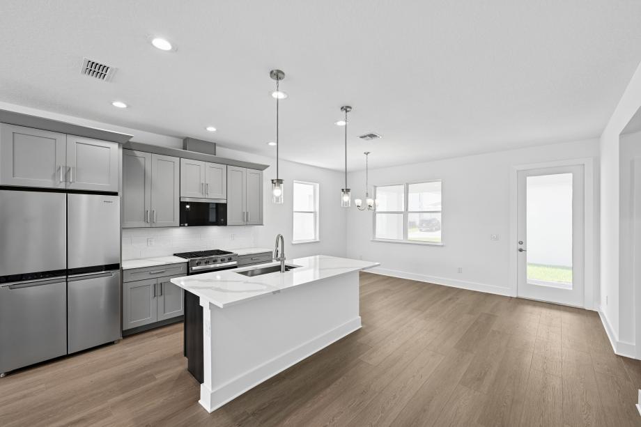 Well-appointed kitchens with large center islands and walk-in pantries