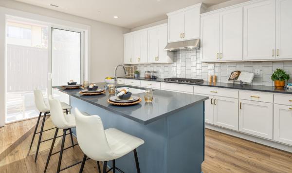 Kitchen features white shaker-style cabinetry