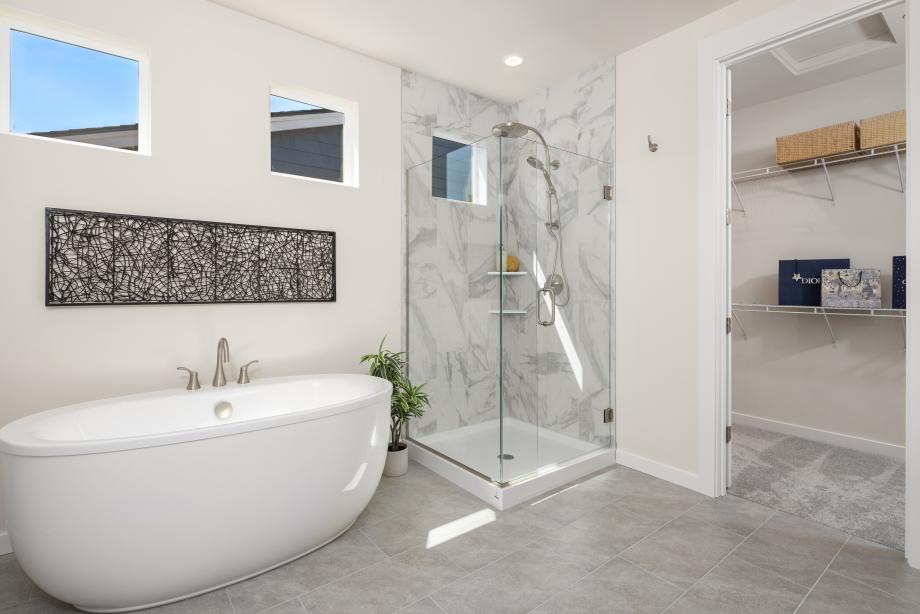 Primary bathroom features a dual-sink vanity with quartz countertop