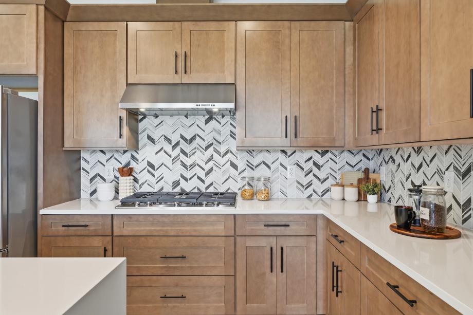 Gourmet kitchen boasting a large center island with quartz countertops