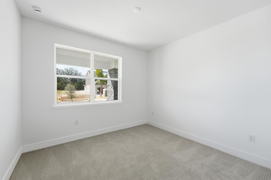 Well appointed and versatile, the secondary bedroom offers comfort, privacy, and timeless appeal.