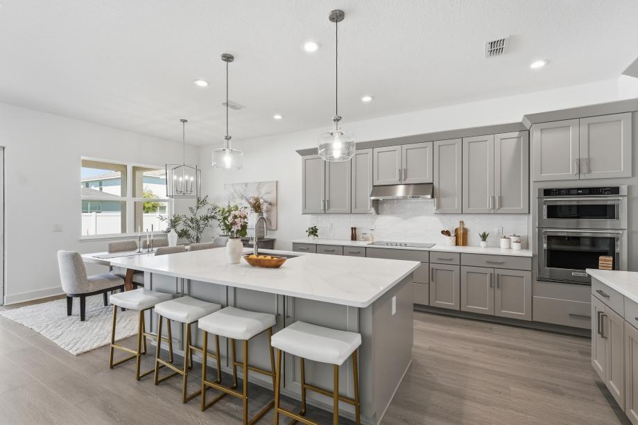 Gourmet kitchen boasting a large center island with quartz countertops