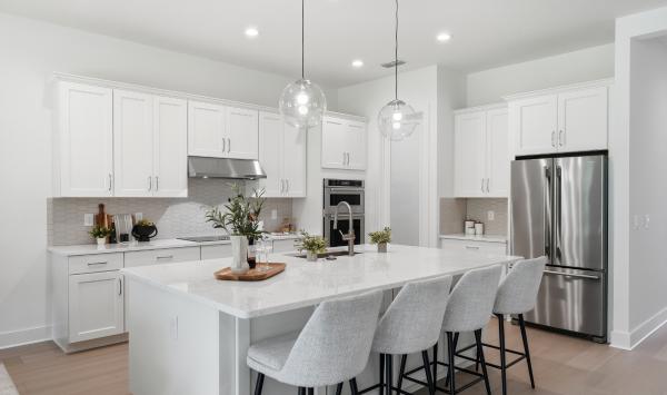 Well-appointed kitchens with large center islands and walk-in pantries
