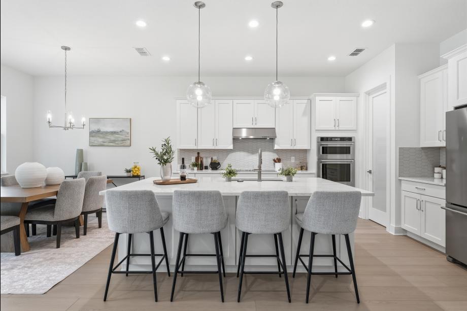 Gourmet kitchens with generous cabinetry and oversized islands
