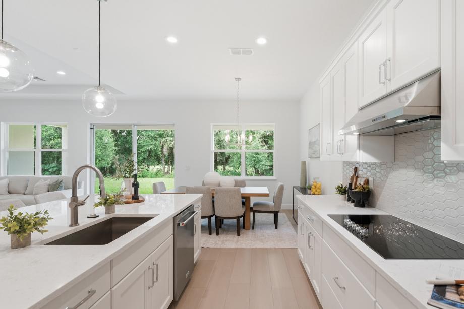 Well-appointed kitchens with large center islands and walk-in pantries