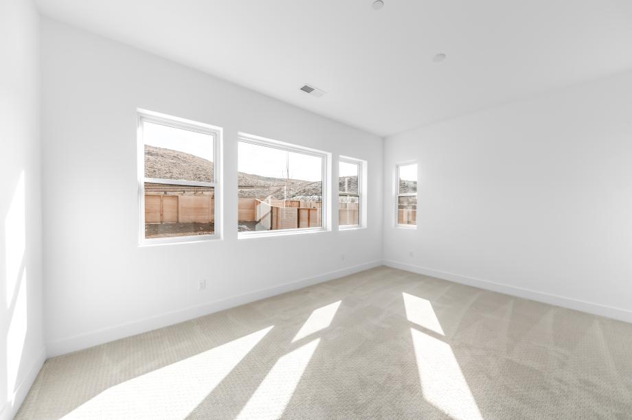 Large primary bedroom suite with a seating area and ample light