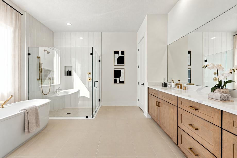 Luxurious primary bath with freestanding tub, glass-enclosed shower, and dual-sink vanity