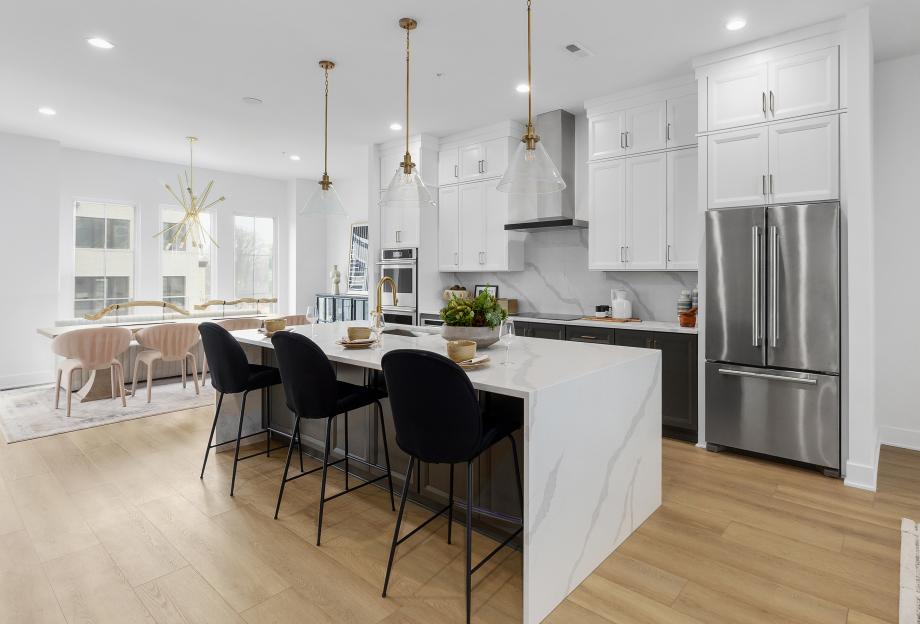 Gourmet kitchen boasts a large center waterfall island