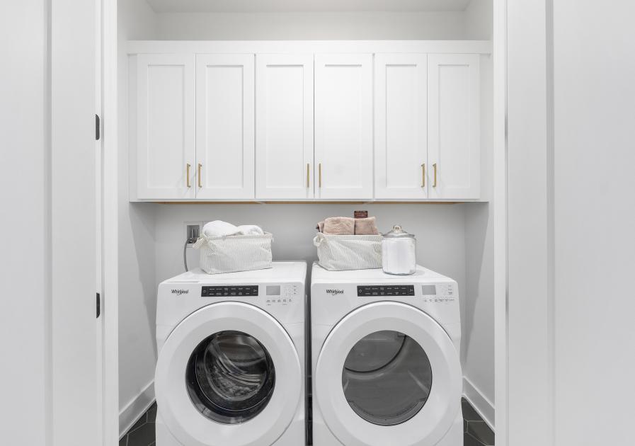 Laundry room conveniently located near primary and secondary bedrooms