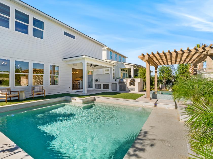 Large backyard with a pool and spa