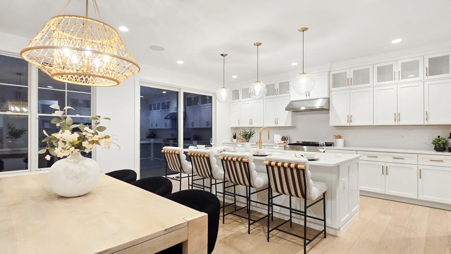 Kitchen boasts a large center island, quartz countertops, and JennAir appliances