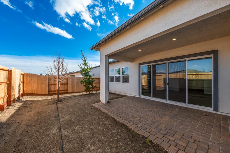 Spacious backyard with a covered patio ideal for outdoor living