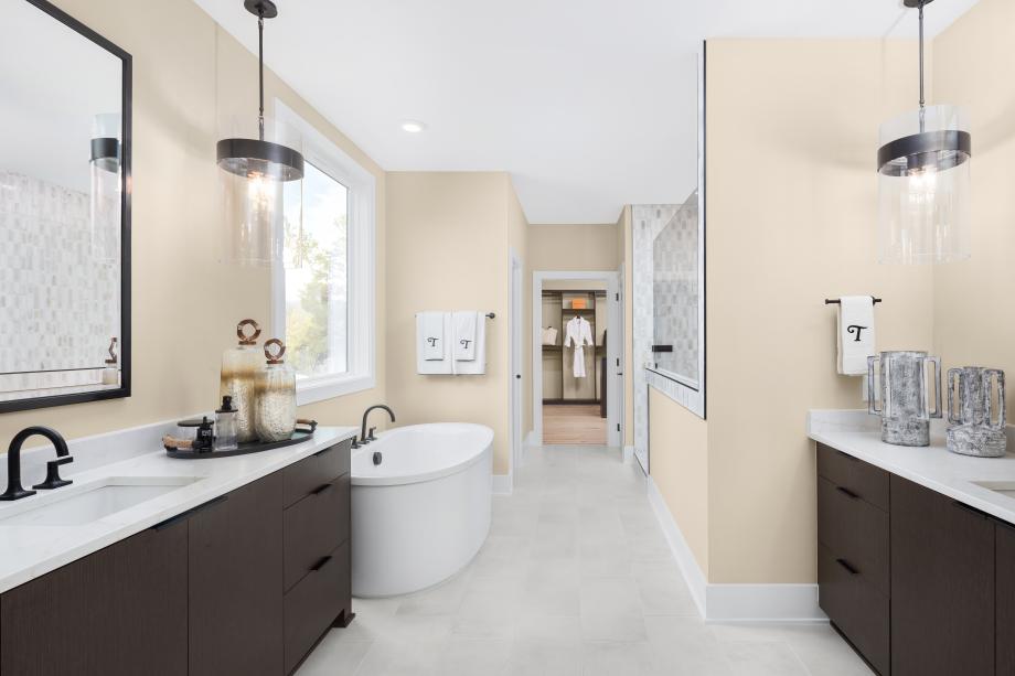 Primary bath featuring dual vanities and soaking tub