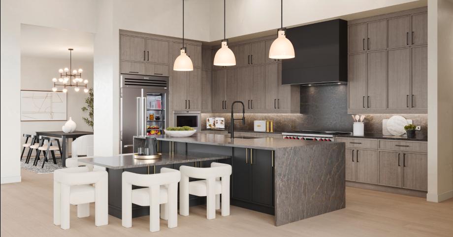 Impressive kitchen with stacked cabinets, oversized island, and stainless steel appliances