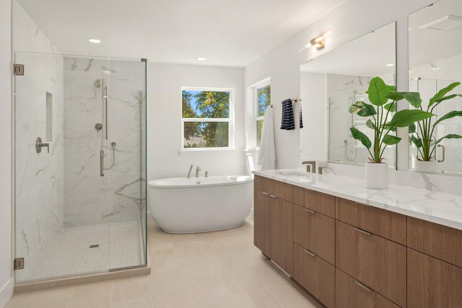 Primary bathroom features a freestanding tub and walk-in shower