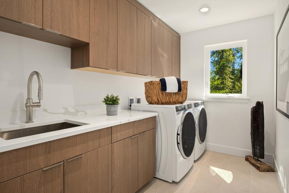 Spacious laundry room with built-in cabinets