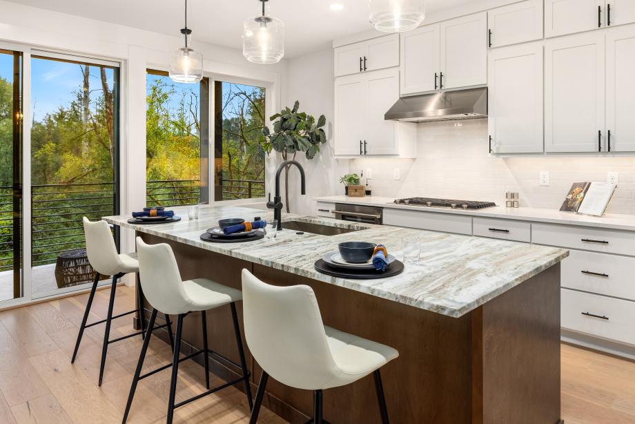 Kitchen island boasts a beautiful dolomite slab countertop with contrasting stained cabinets