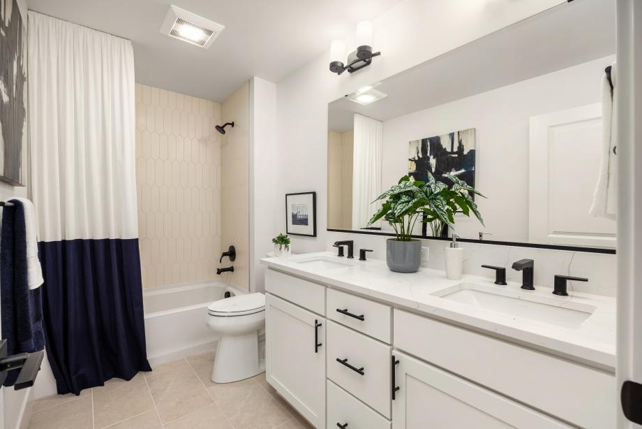 Secondary hallway bathroom features a dual-sink vanity
