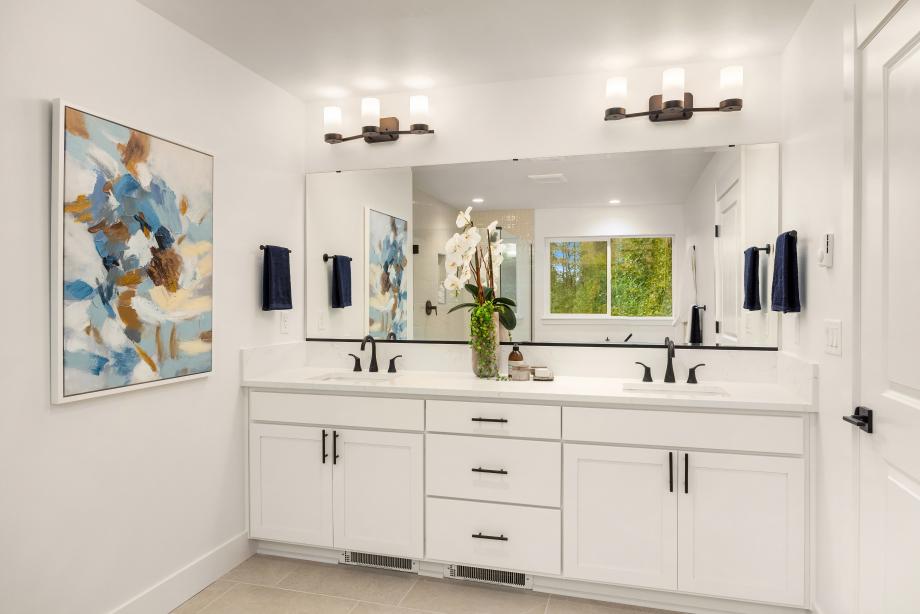Primary bathroom features a dual-sink vanity with quartz countertop
