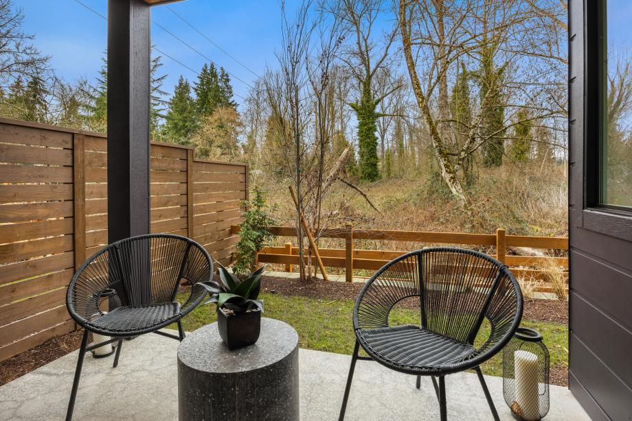 Covered patio on the first floor offers views of the protected greenbelt