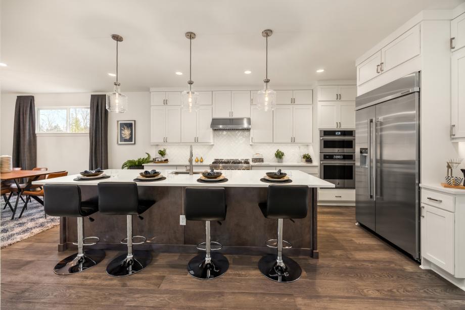 Well-designed kitchen with white shaker double-stacked cabinets