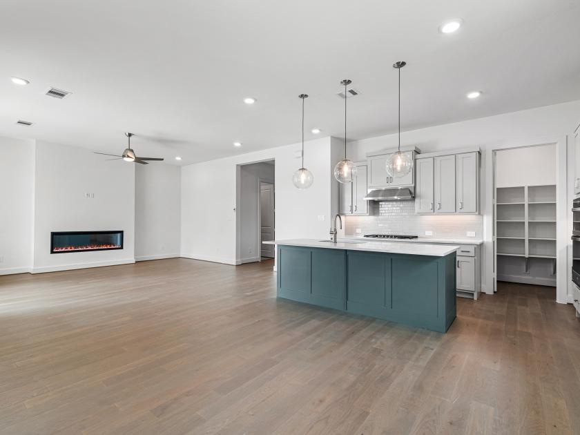 Chef-inspired kitchen with two-tone cabinetry and spacious walk-in pantry