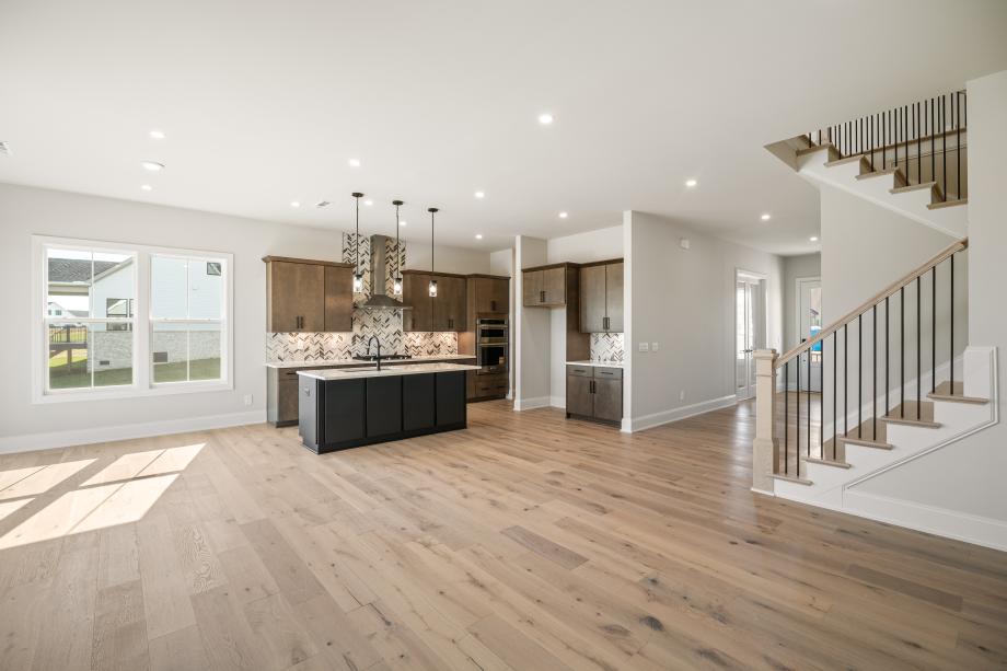 Kitchen connectivity to great room with elegant contrasting fireplace surround