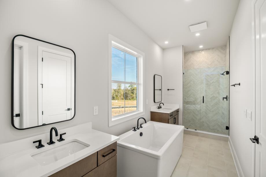Primary bathroom with soaking tub and dual vanities