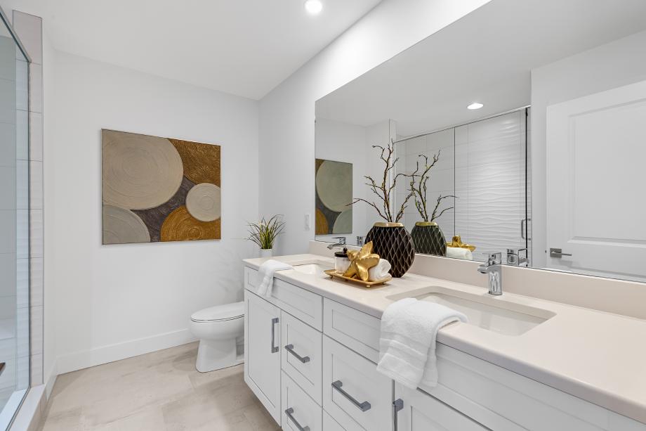 Spa-inspired primary bathroom featuring a glass-enclosed shower