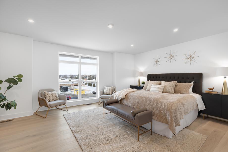 Luxurious primary bedroom suite with endless natural light