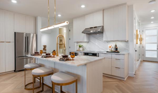 Well-designed kitchen offers a central island with breakfast bar
