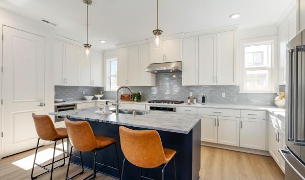 Open-concept kitchen with large central island, sleek cabinetry, and ample storage