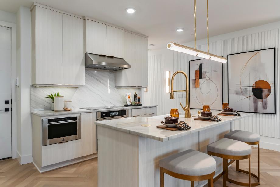 Representative Photo - Stylish kitchen features a central island with a breakfast bar