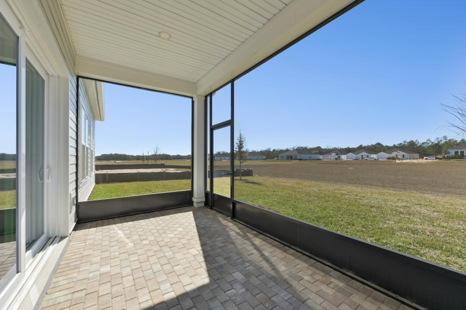 Covered lanai with screen ideal for outdoor living, dining, and entertaining