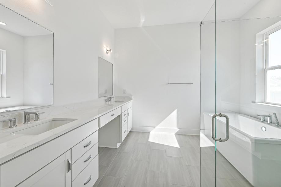 Spa-like primary bathroom with large soaking tub and walk-in shower
