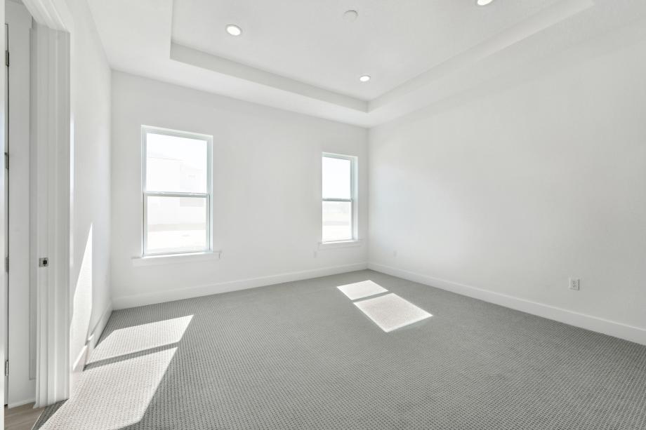 Large primary bedroom suite with a seating area and ample light