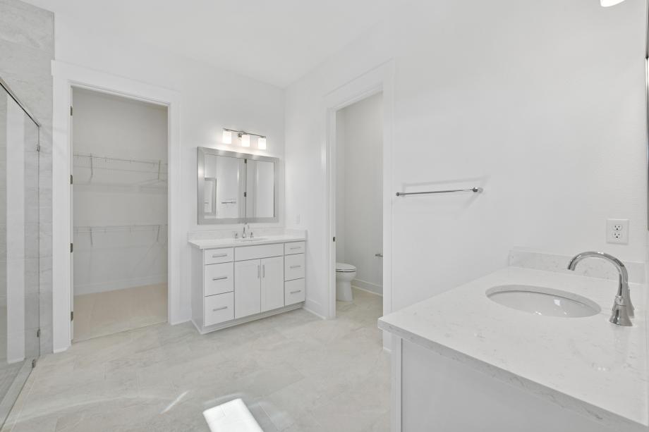 Primary bathroom with walk-in shower and split vanity