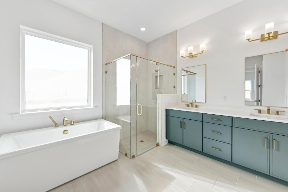 Spa-like primary bathroom with a large walk-in shower and freestanding bath
