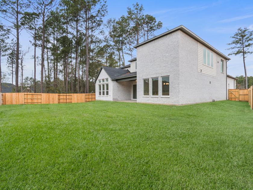 Spacious backyard with green space and covered patio