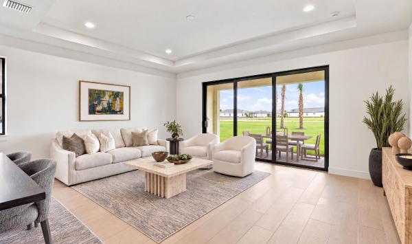Beautiful great room with tray ceiling offers views to the covered lanai