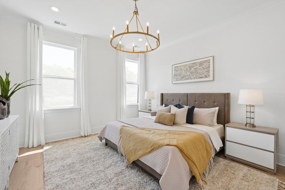 Luxurious first-floor primary bedroom suite with walk-in closet