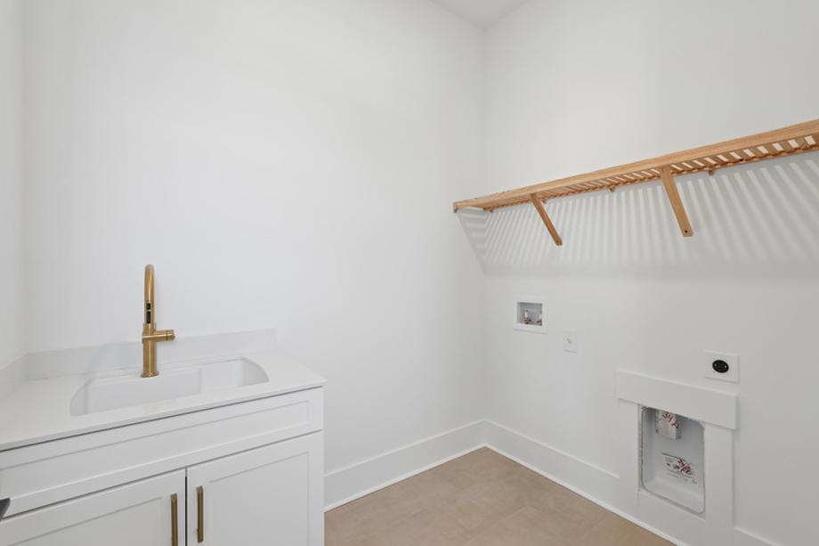 Thoughtfully designed laundry room with ample cabinet space