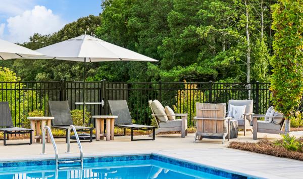 Resort-style pool with in-pool loungers, outdoor dining space and cabanas